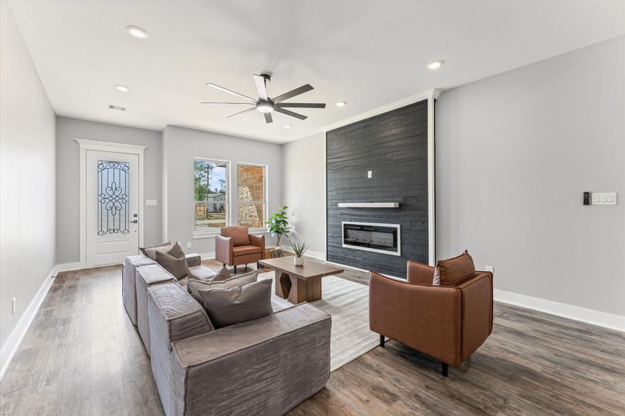 Natural light flows through large windows, accentuating the open layout and laminate flooring throughout. Natural light flows through large windows, accentuating the open layout and laminate flooring throughout.