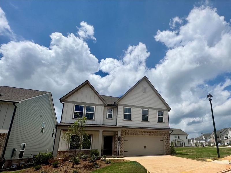 Front exterior of a new home in Eastlyn Crossing - Single Family, Flowery Branch, GA, highlighting curb appeal (Image 24). Front exterior of a new home in Eastlyn Crossing - Single Family, Flowery Branch, GA, highlighting curb appeal (Image 24).