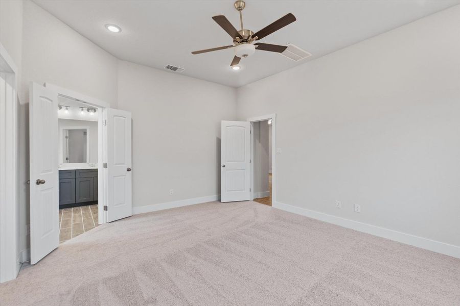 A spacious bedroom offers a neutral canvas, ready for personalized touches. A spacious bedroom offers a neutral canvas, ready for personalized touches.