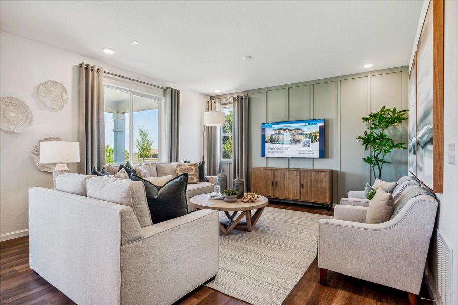 A living room with a tv and couches. A living room with a tv and couches.