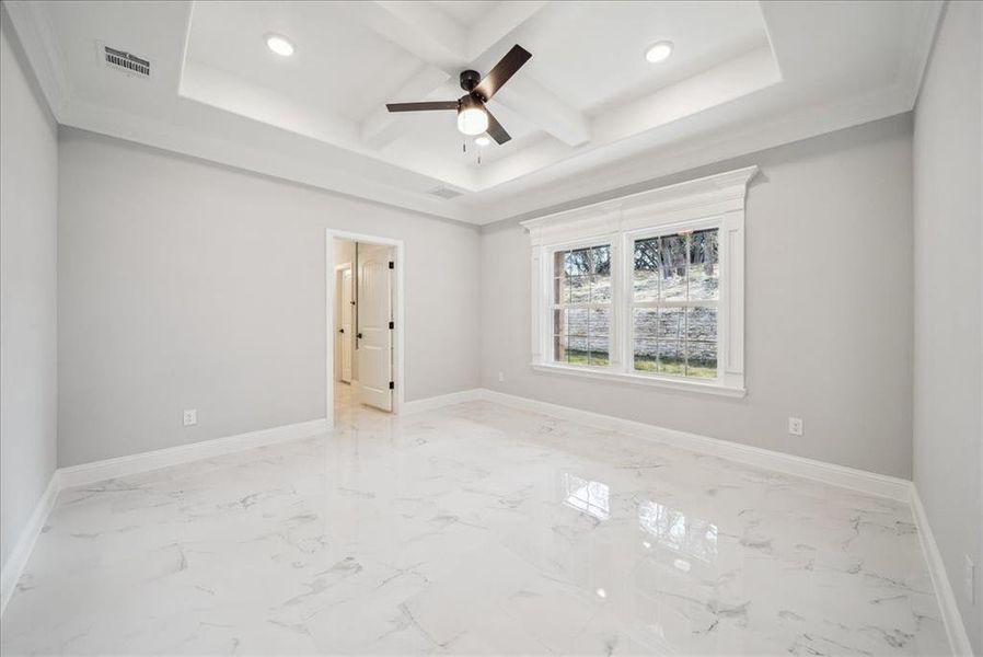 Spare room with ceiling fan, ornamental molding, beam ceiling, and coffered ceiling