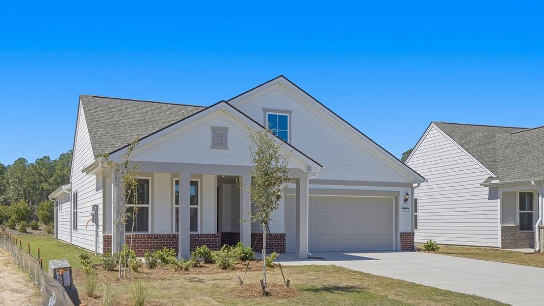 Front exterior of a new home in Sun City Hilton Head, Bluffton, SC, highlighting curb appeal (Image 1). Front exterior of a new home in Sun City Hilton Head, Bluffton, SC, highlighting curb appeal (Image 1).