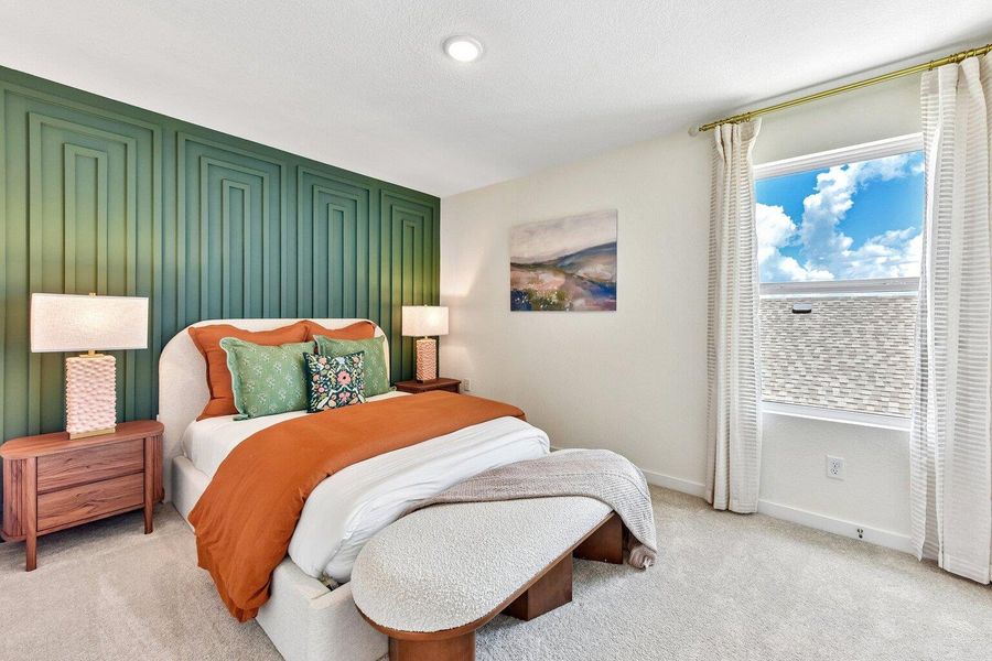 A feature wall with geometric paneling adds character to this serene bedroom.