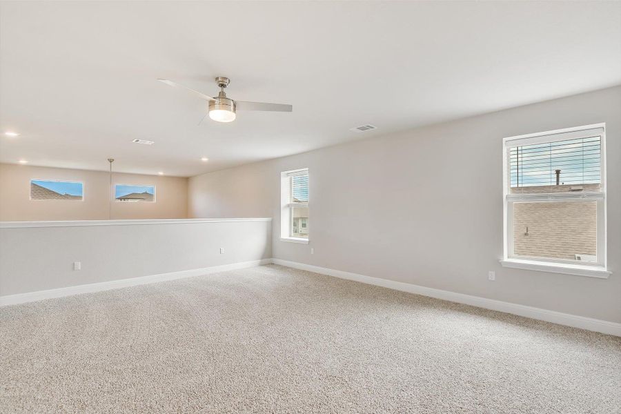 Carpeted spare room featuring baseboards, visible vents, a ceiling fan, and recessed lighting