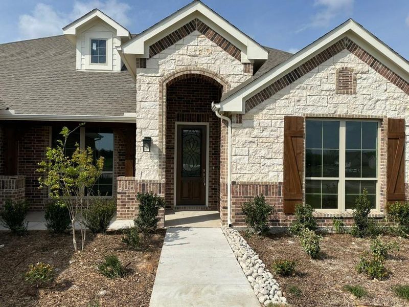 Front exterior of a new home in Fannin Ranch, Leonard, TX, highlighting curb appeal (Image 17).