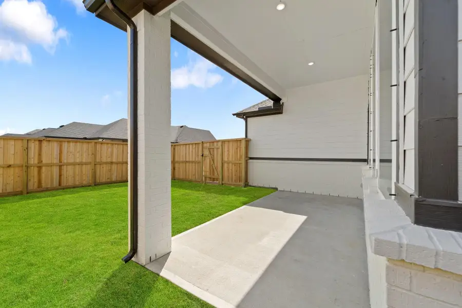 Front exterior of a new home in Riceland, Mont Belvieu, TX, highlighting curb appeal (Image 9).