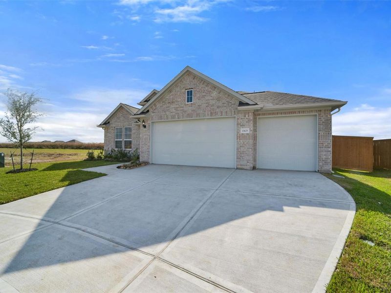 Front exterior of a new home in Lago Mar, Texas City, TX, highlighting curb appeal (Image 2). Front exterior of a new home in Lago Mar, Texas City, TX, highlighting curb appeal (Image 2).