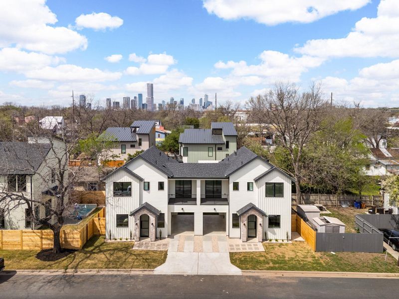 Modern farmhouse with a garage, board and batten siding, driveway, a view of skyline, and a balcony