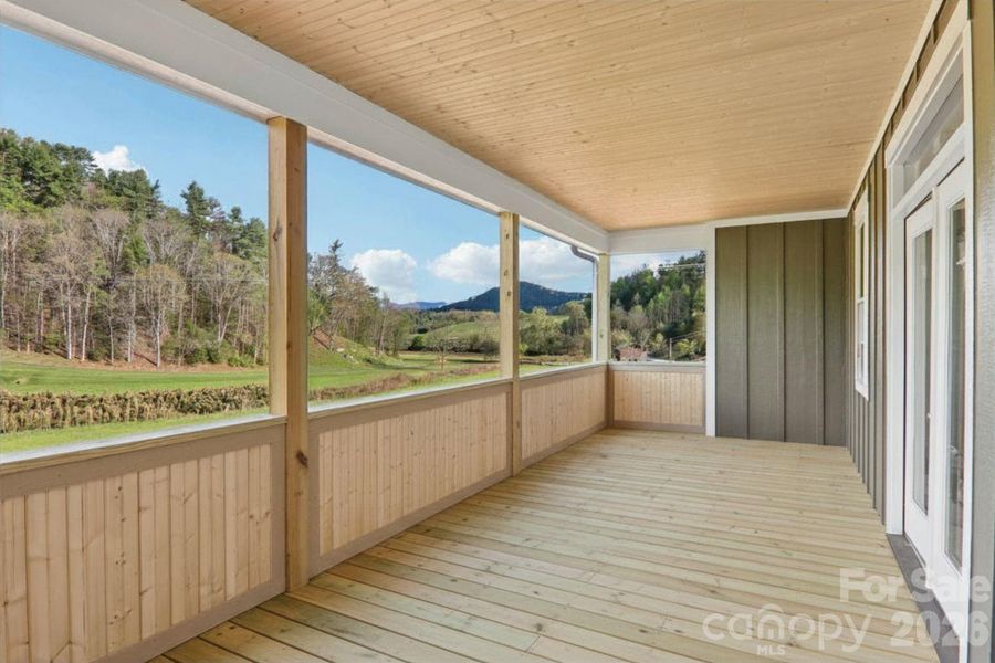 Back covered deck off of the main living room overlooking the mounatins facing east.