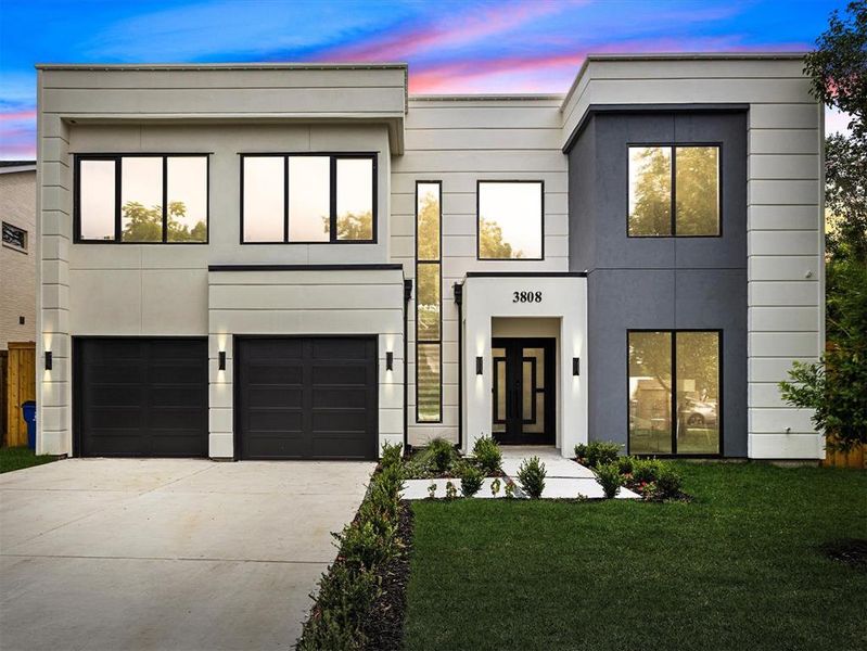 Modern home with a garage and a lawn