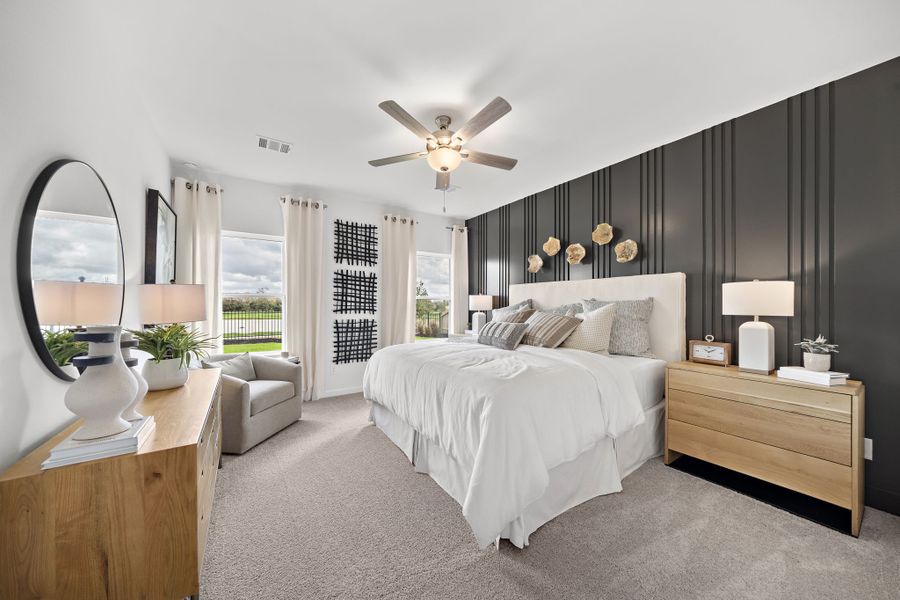 A bedroom with a large bed and a large fan.