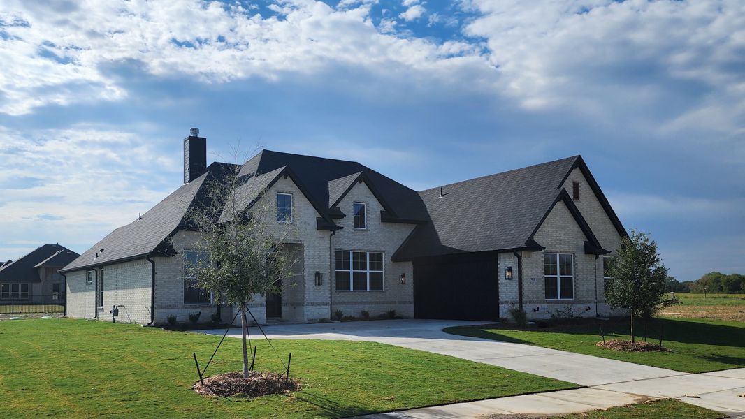 Front exterior of a new home in Paloma Ranches, Justin, TX, highlighting curb appeal (Image 11). Front exterior of a new home in Paloma Ranches, Justin, TX, highlighting curb appeal (Image 11).