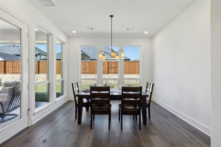 Dining area featuring a notable chandelier and dark hardwood / wood-style floors