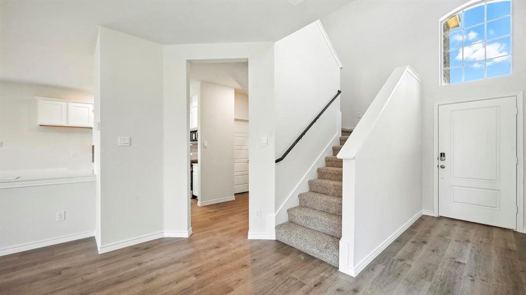 Entrance foyer with stairway and wood finished floors