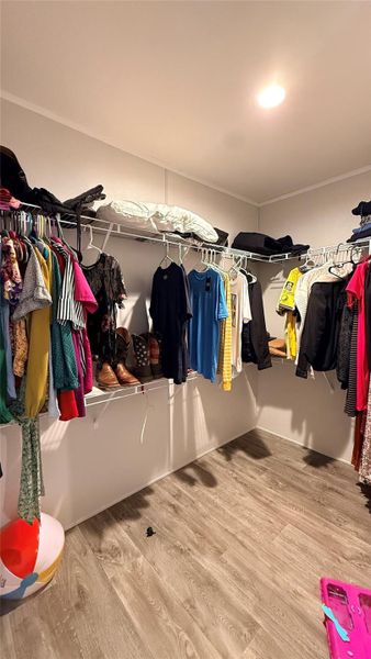 Ample storage solutions define this practical walk-in closet with durable flooring. Ample storage solutions define this practical walk-in closet with durable flooring.