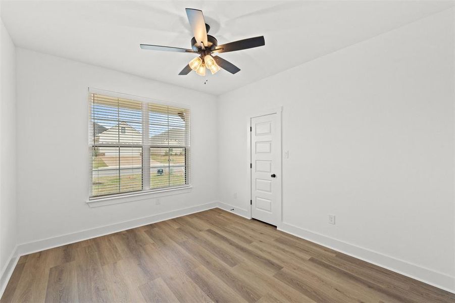 Spare room with light wood-style floors and ceiling fan