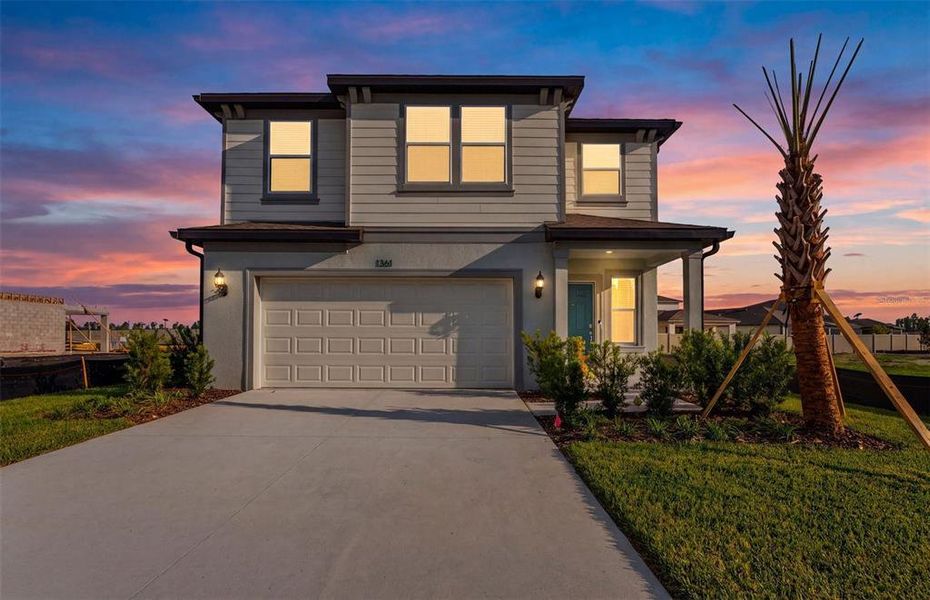Front exterior of a new home in Riverwood, Zephyrhills, FL, highlighting curb appeal (Image 1). Front exterior of a new home in Riverwood, Zephyrhills, FL, highlighting curb appeal (Image 1).