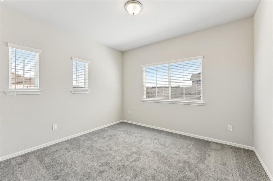 This versatile bedroom offers a comfortable and inviting space.