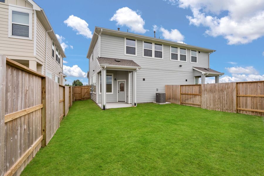Front exterior of a new home in Meridiana, Manvel, TX, highlighting curb appeal (Image 15).