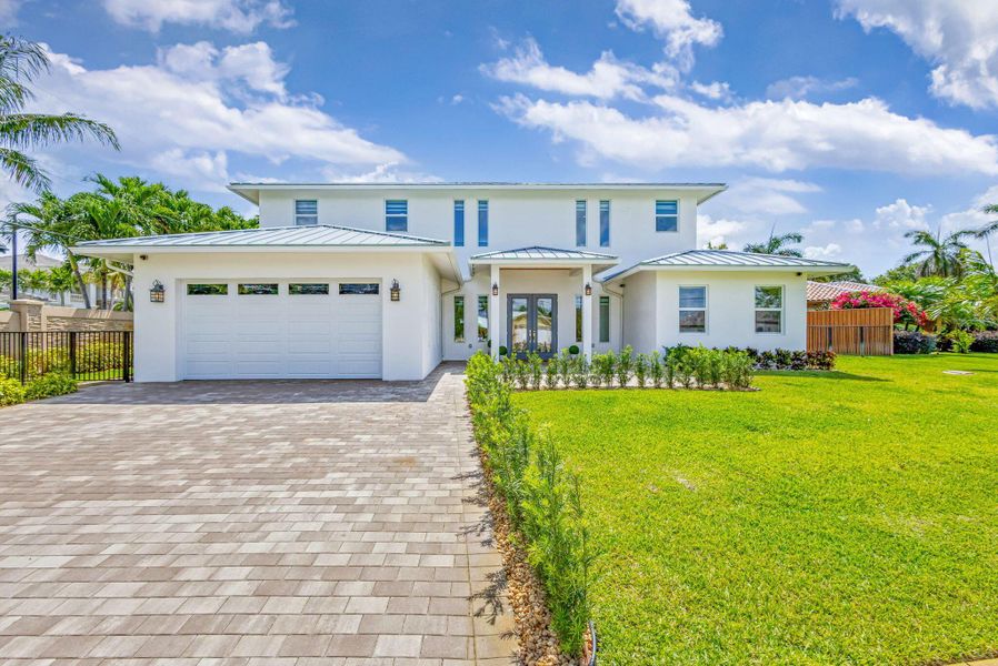 Front exterior of a new home in , North Palm Beach, FL, highlighting curb appeal (Image 24). Front exterior of a new home in , North Palm Beach, FL, highlighting curb appeal (Image 24).