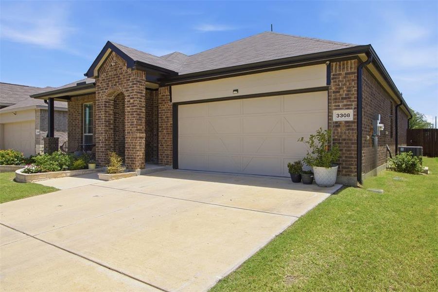 Front exterior of a new home in Kings Ridge, Denton, TX, highlighting curb appeal (Image 23). Front exterior of a new home in Kings Ridge, Denton, TX, highlighting curb appeal (Image 23).