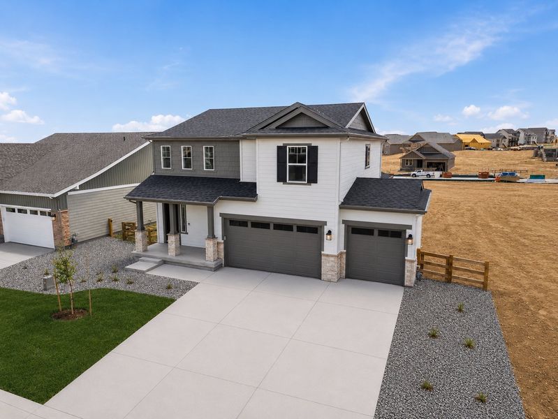 Front exterior of a new home in The Town Collection at Independence, Elizabeth, CO, highlighting curb appeal (Image 2). Front exterior of a new home in The Town Collection at Independence, Elizabeth, CO, highlighting curb appeal (Image 2).