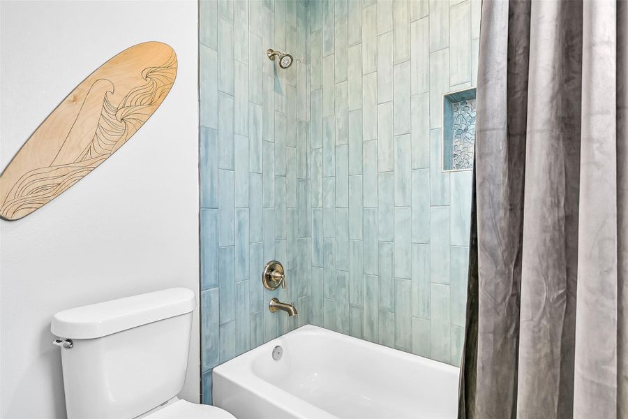Bright coastal finishes and a practical layout make this bathroom ideal for guests, family, or vacation rental use. The tub and shower combo adds everyday convenience buyers appreciate.