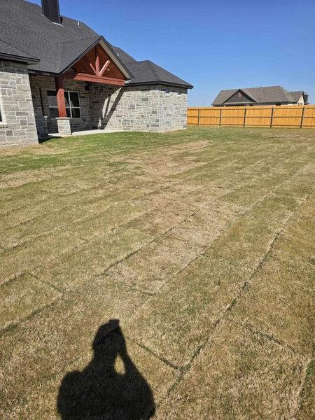 Fenced backyard with a patio area Fenced backyard with a patio area