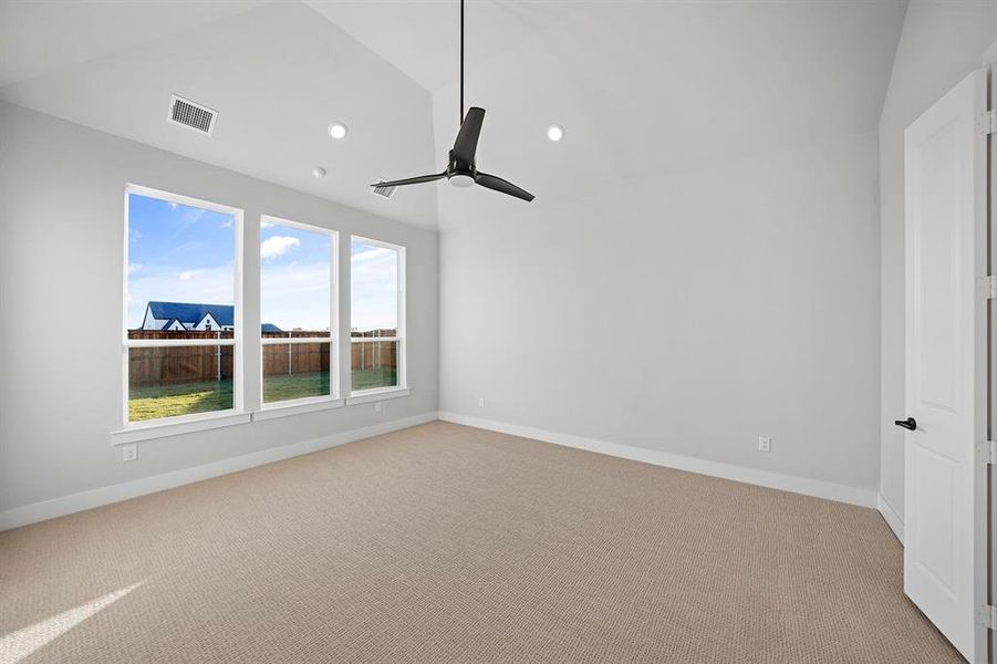 Spare room featuring light carpet, vaulted ceiling, recessed lighting, and ceiling fan Spare room featuring light carpet, vaulted ceiling, recessed lighting, and ceiling fan