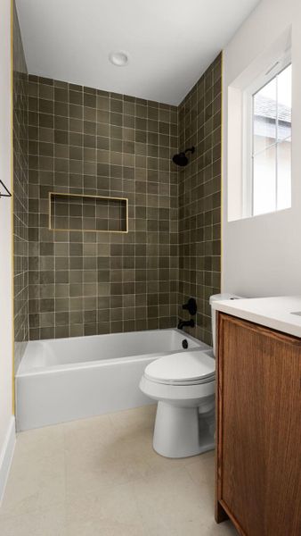 Full bath featuring tub / shower combination, vanity, and light tile patterned floors