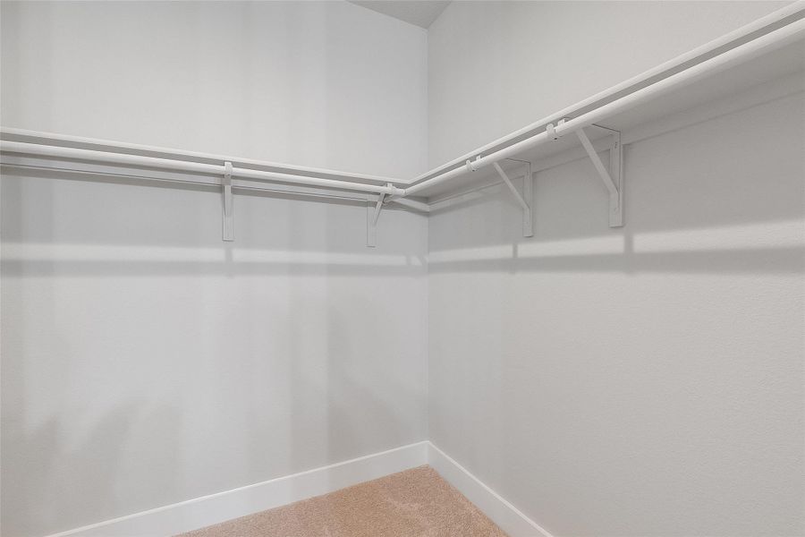 Spacious primary walk in closet Spacious primary walk in closet