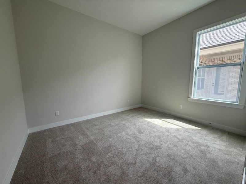 Carpeted empty room with baseboards