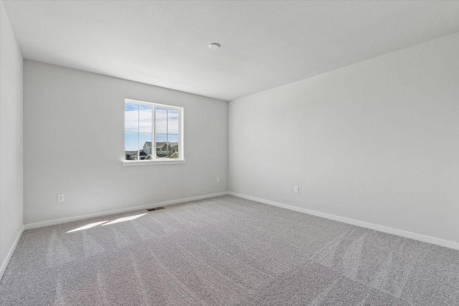A room with a window and carpet. A room with a window and carpet.
