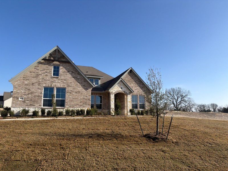 Front exterior of a new home in Grayson Ridge, Van Alstyne, TX, highlighting curb appeal (Image 1). Front exterior of a new home in Grayson Ridge, Van Alstyne, TX, highlighting curb appeal (Image 1).