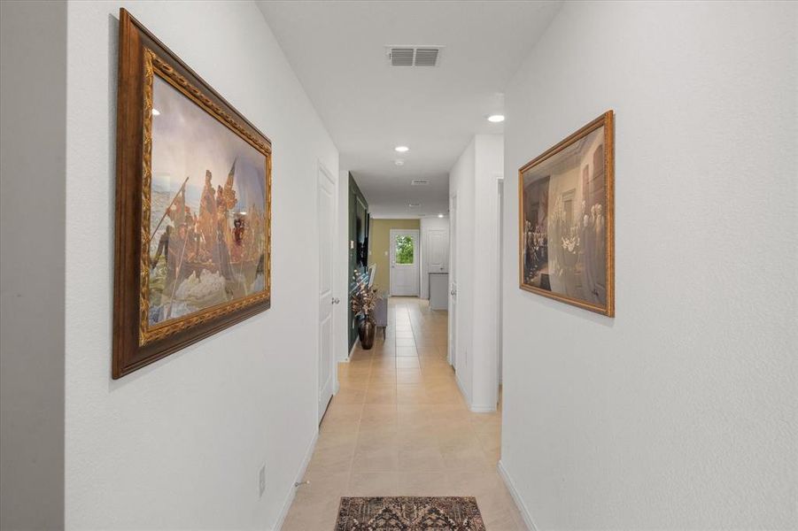 Hallway featuring recessed lighting and light tile patterned floors