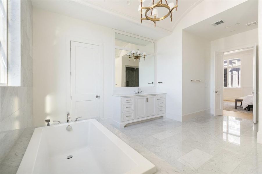 Unwind in the comfort of the built-in soaking tub, designed to offer a relaxing retreat with its timeless elegance and functional style. (photo of interior model home with smaller floor plan)