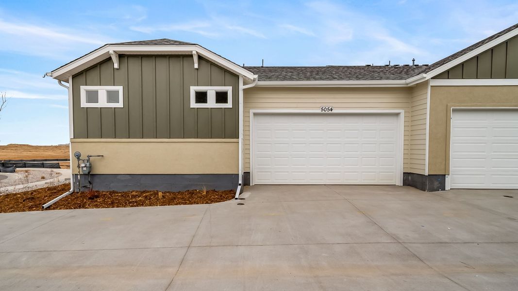 Front exterior of a new home in The Reserve at Green Valley Ranch Aurora, Aurora, CO, highlighting curb appeal (Image 24). Front exterior of a new home in The Reserve at Green Valley Ranch Aurora, Aurora, CO, highlighting curb appeal (Image 24).