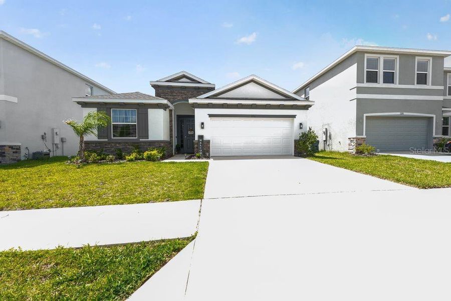 Front exterior of a new home in Waterford, Brooksville, FL, highlighting curb appeal (Image 26).