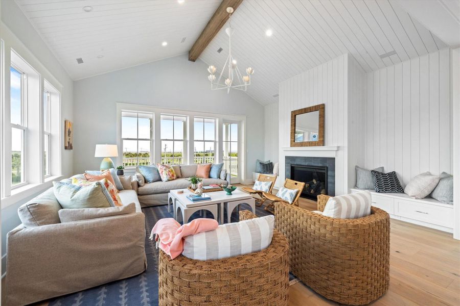 Living Room offers a cathedral ceiling with painted shiplap and large stained beam