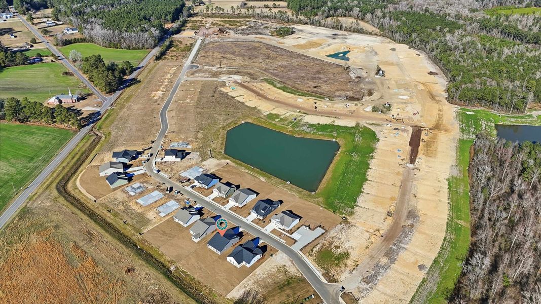 Aerial view of property and surrounding area with a large body of water