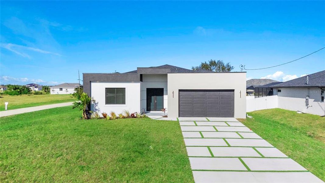 Front exterior of a new home in , Cape Coral, FL, highlighting curb appeal (Image 1). Front exterior of a new home in , Cape Coral, FL, highlighting curb appeal (Image 1).