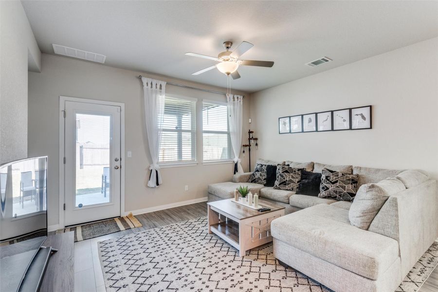 Living room featuring wood finished floors and a ceiling fan