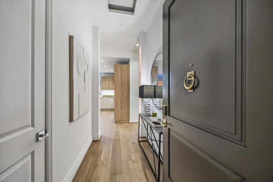 A welcoming entry hallway leads into the home, highlighted by clean lines, high ceilings, and elegant finishes that create a bright and inviting first impression.