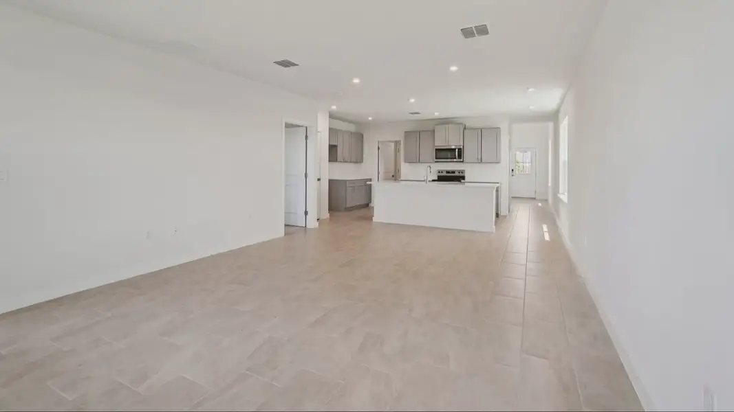 Living Area with View of the Kitchen in the Jupiter in Hamilton Bluff located in Haines City, FL.
