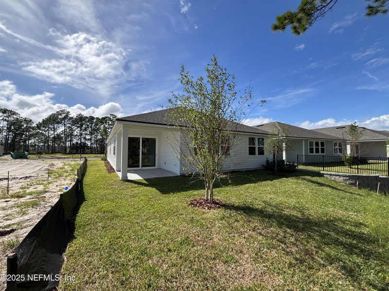 Front exterior of a new home in The Magnolia Series at Reserve East, Flagler Beach, FL, highlighting curb appeal (Image 20).