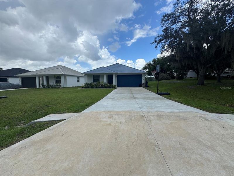 Front exterior of a new home in , Osteen, FL, highlighting curb appeal (Image 18).