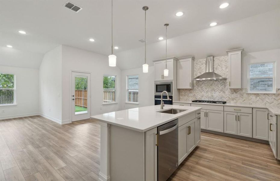 Airy kitchen with oversized island *real home pictured