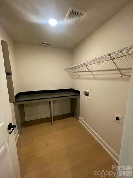 Laundry room with granite countertop on folding table