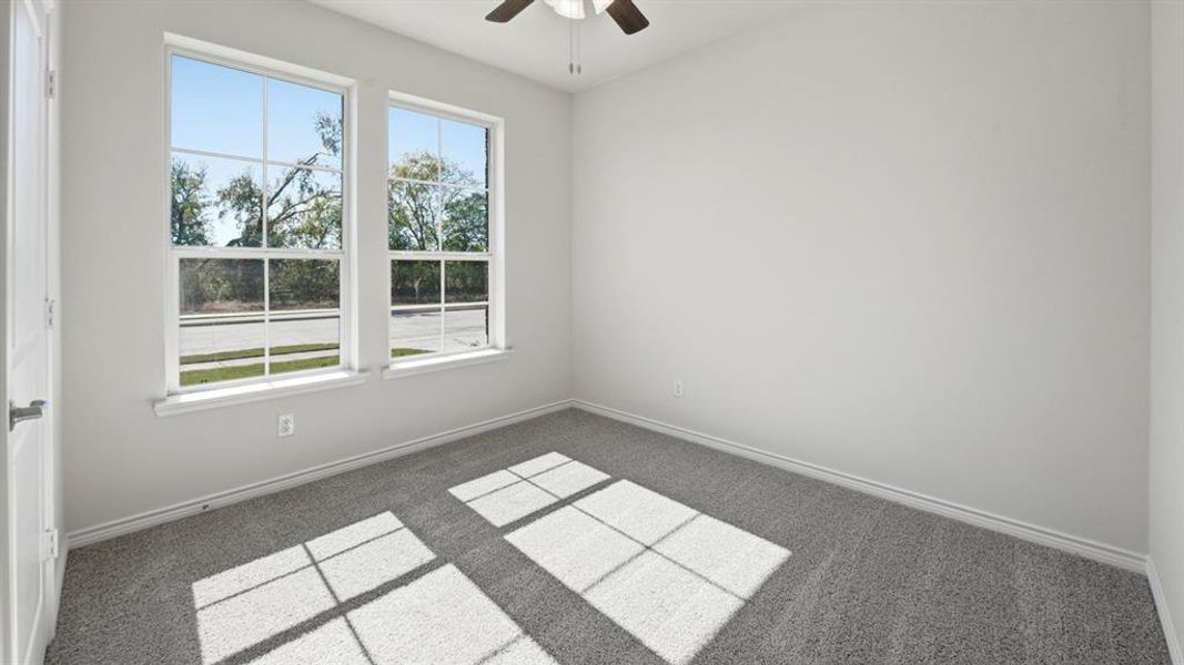 Empty room with a ceiling fan and carpet Empty room with a ceiling fan and carpet