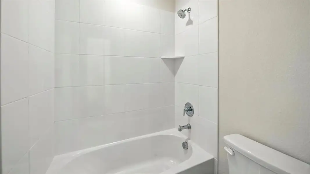 Full bath featuring shower / tub combination and a textured wall